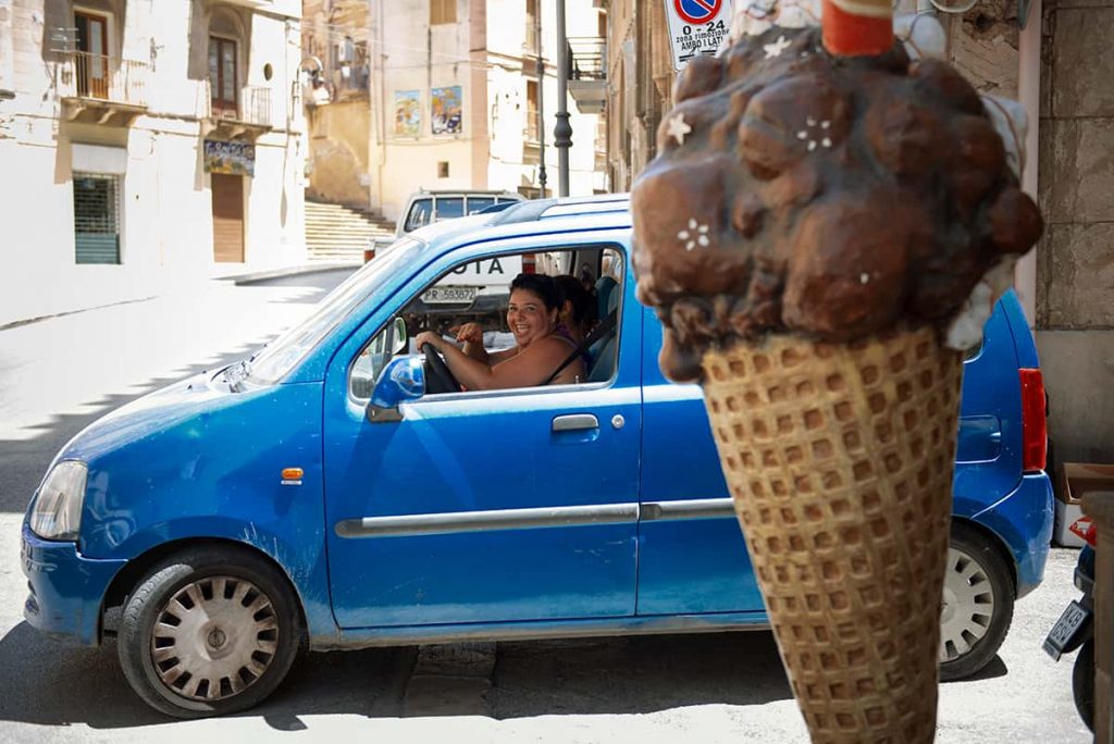 woman driving a blue car in sicily 