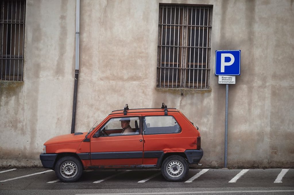 parking in sicily tips- a man in red old school car