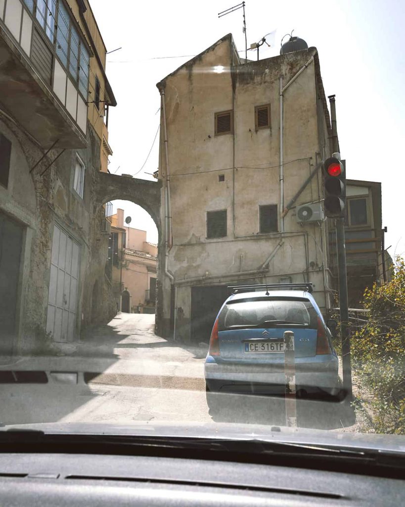 sicily driving tips- narrow mountain town road and a traffic light