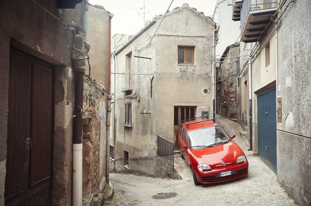 red car parked in Gangi, sicily old town- sicily driving tips