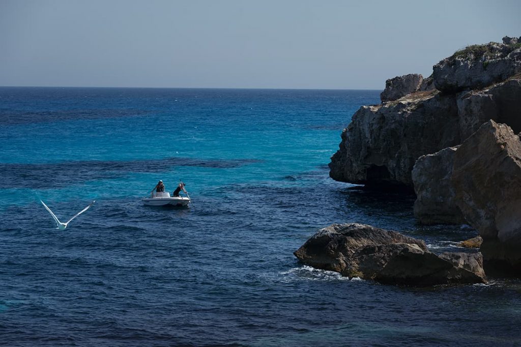 small boat in favignana bue marino cove, sicily