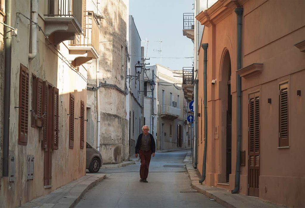 man walking in the street of Favignana island, Sicily