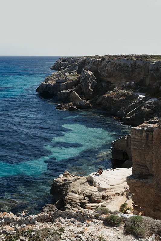 blue water beach with rocky shores