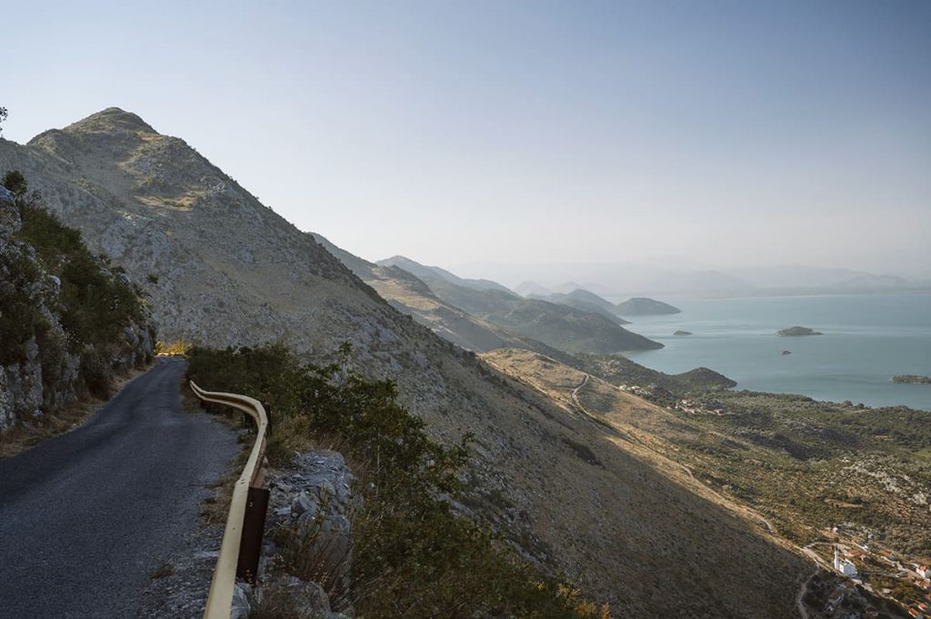 a narrow cliff road in Montenegro lake Skadar national park at sunset= Montenegro driving tips