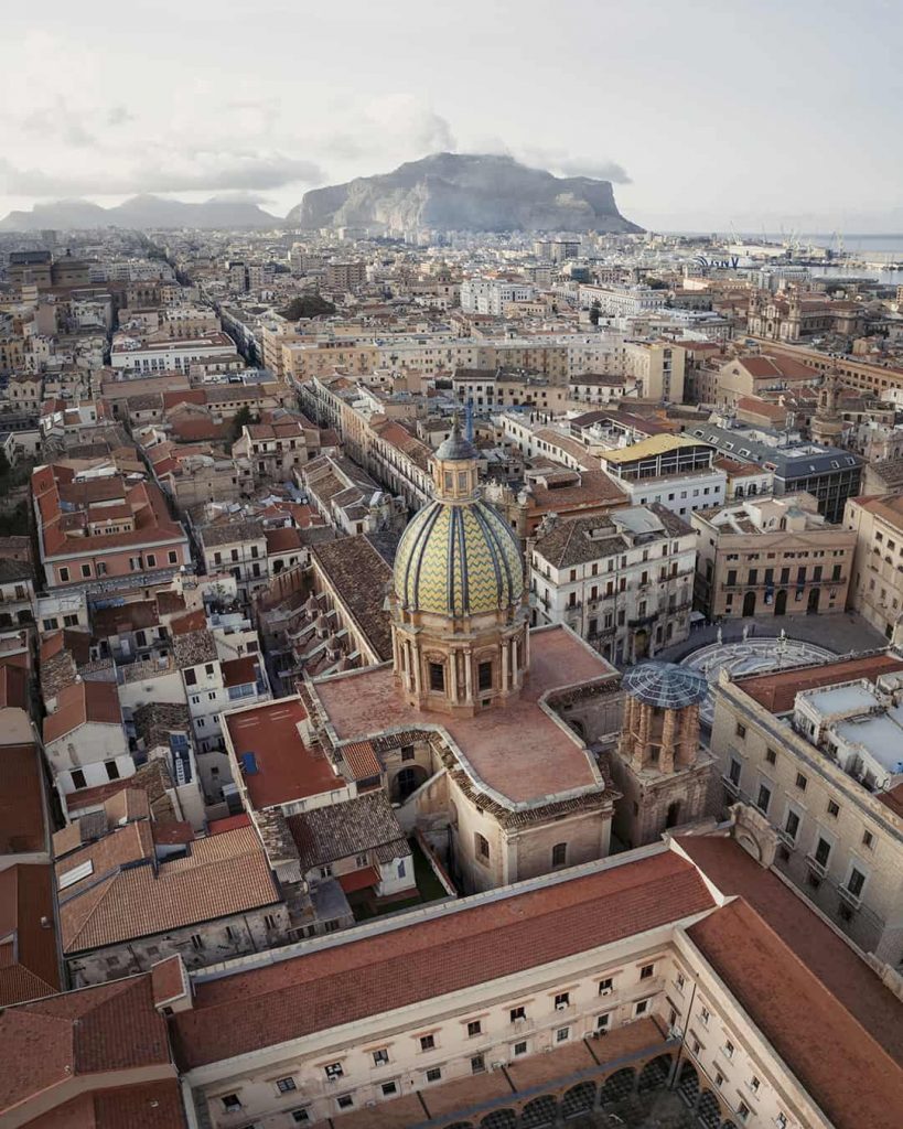 drone shot of palermo fountain of fame and mount pelegrino in the background