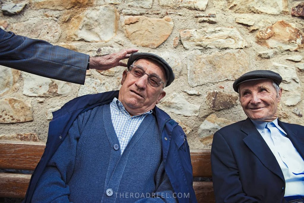 Local gentlemen joking around while I am photographing them in petralia soprana sicily
