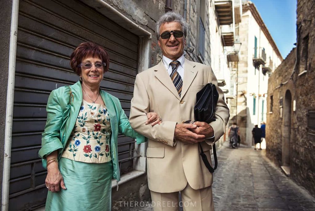 Elegantly dressed Sicilian couple coming out for afternoon passegiata in Madonie mountain village