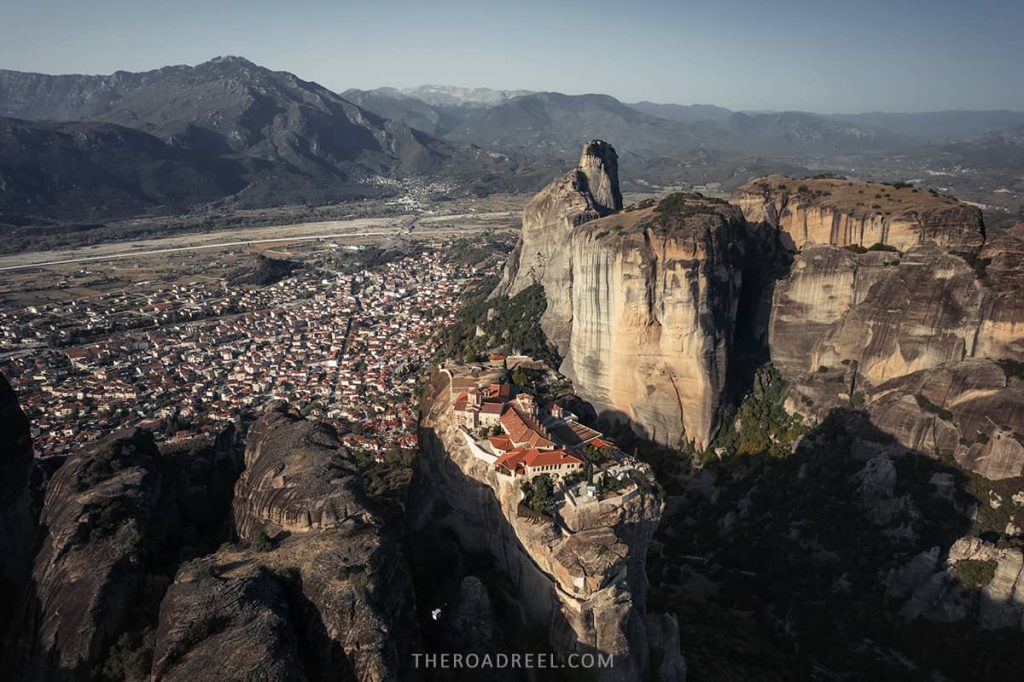 Holly Trinity monastery with Kalambaka town in the background aerial view, Meteora, Greece