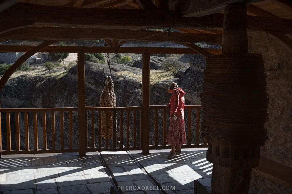 Guide to visiting Meteora monasteries in Greece, the rope basket you can see in this image was used in old days to transport good and even people, Holy Trinity monastery