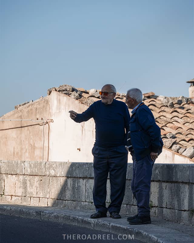 Visiting Ragusa Ibla: two local men chatting on the streets