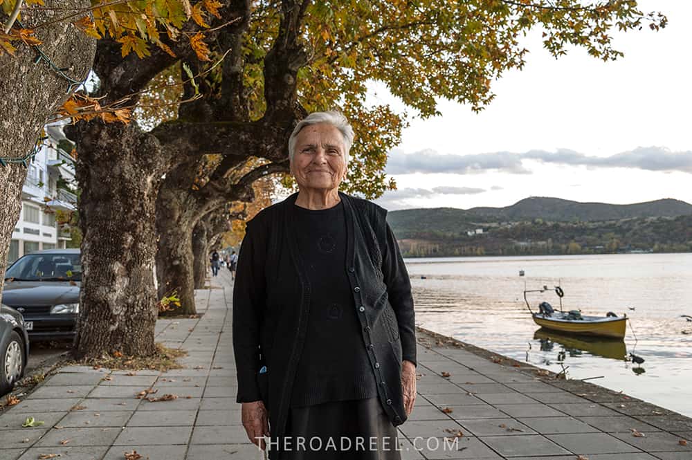 Travel guide to Kastoria, Greece: a friendly curious local woman walking on Orestiada lake promenade