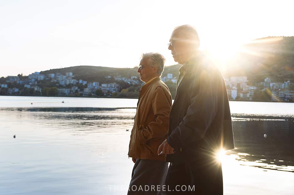 Kastoria lake promenade elderly people strolling at sunset