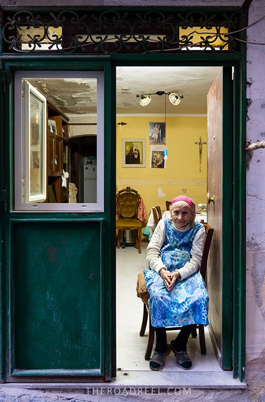 Naples Italy itinerary for one day, old lady sitting at the doorstep in Spanish quarters