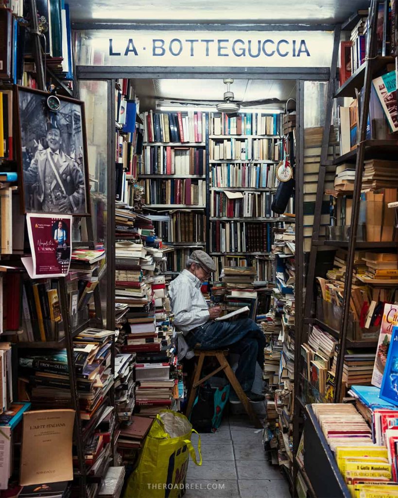 naples, book store, a man sitting surrounded by books and reading