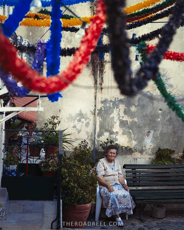 Alfama neighborhood Lisbon, old lady sitting on the bench