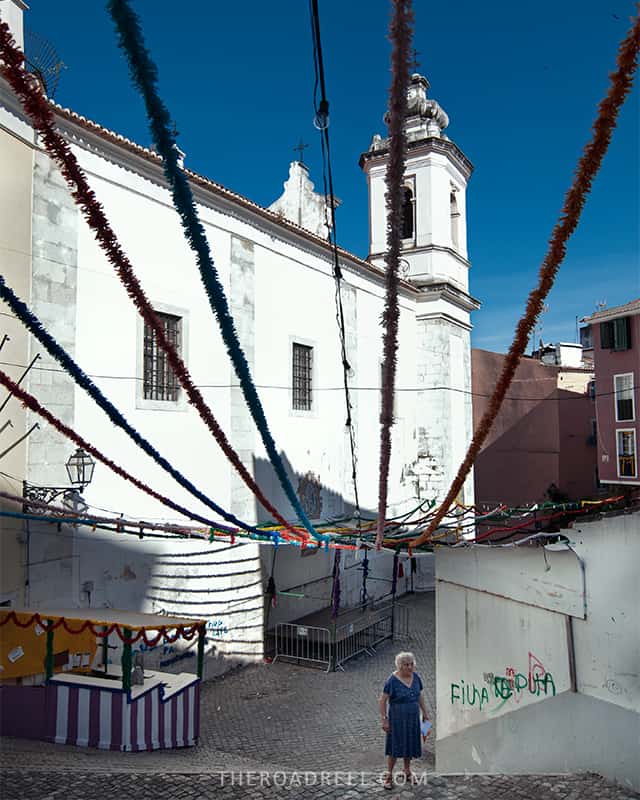 Alfama streets-one day in Lisbon itinerary, old lady walking up the stairs