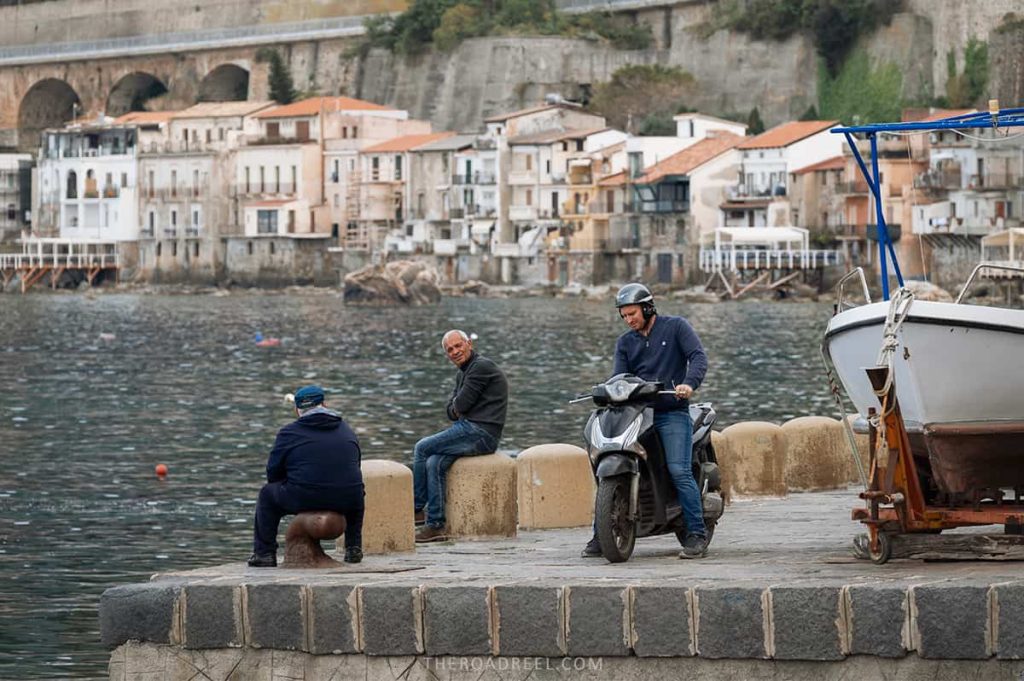 The best things to do in Scilla & Chianalea- men relaxing in Chianalea