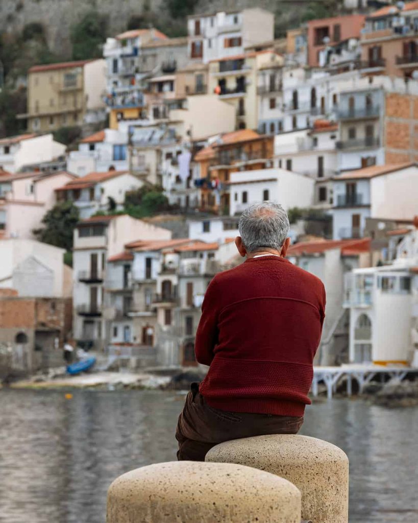 The best things to do in Scilla & Chianalea- a local man contenplating at the waterfront
