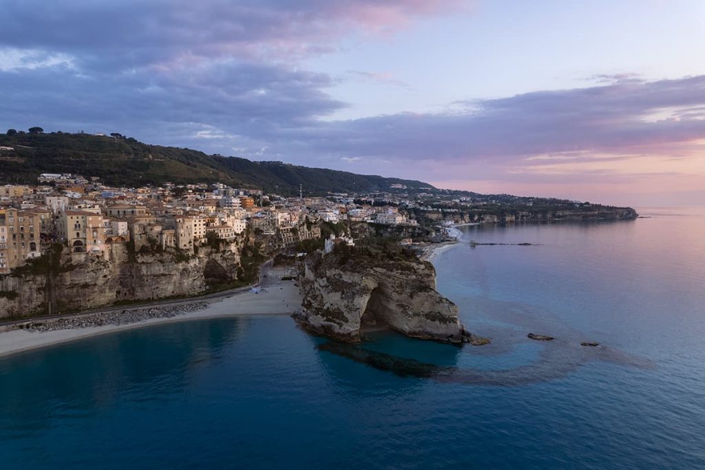 Grotta Palombaro as seen from the air, and Spiaggia a Linguata at the far end, Tropea Italy