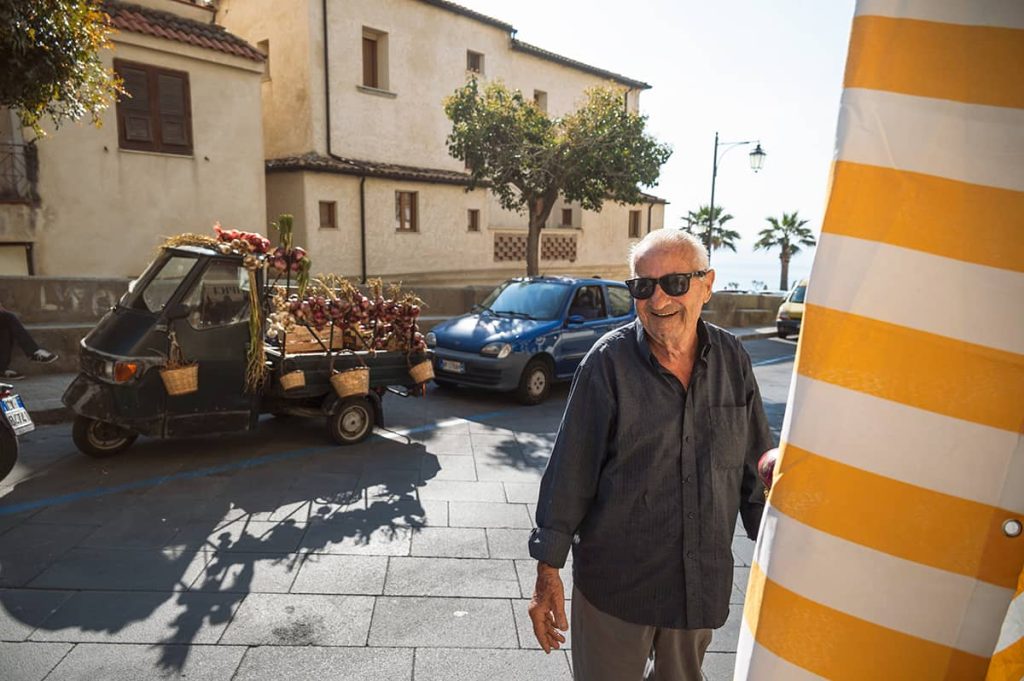 calabria travel tips- a local man at his shop