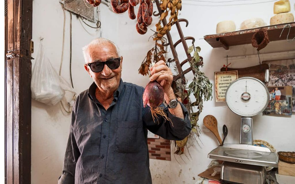 a local man selling onion in his store in Tropea