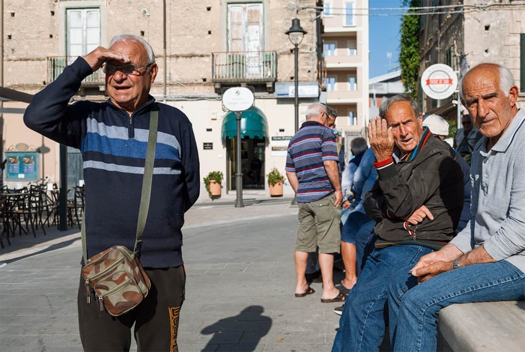 calabria travel tips- old men hanging out in piazza