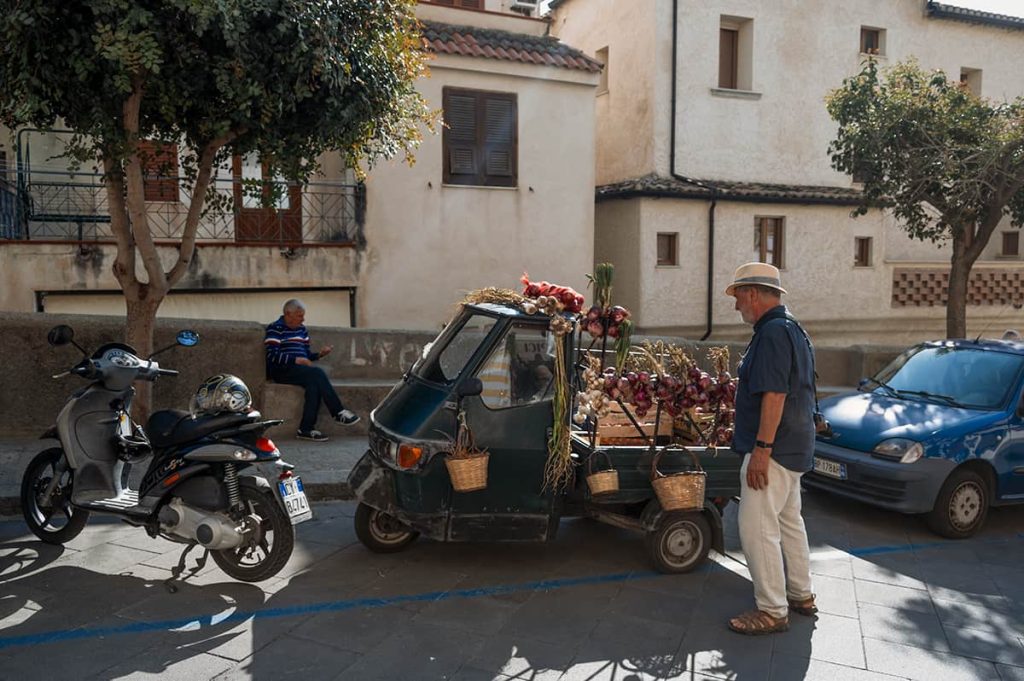 Creative way to present local produce in Tropea, Italy- red onion hanging off tuk tuk in Tropea