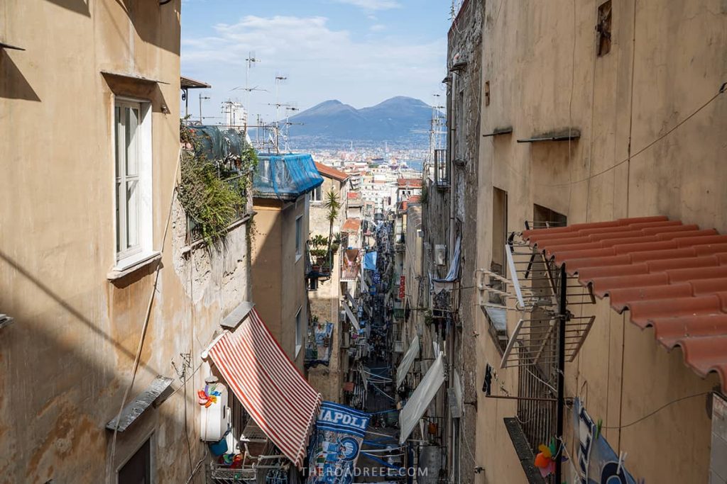 Naples in 2 days: the view of narrow street of Quartieri Spagnoli and Moun vesuvius in the background