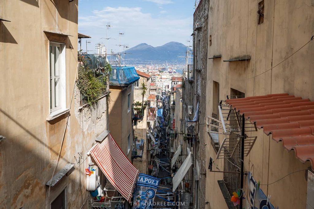 Naples in 2 days: the view of narrow street of Quartieri Spagnoli and Moun vesuvius  in the background