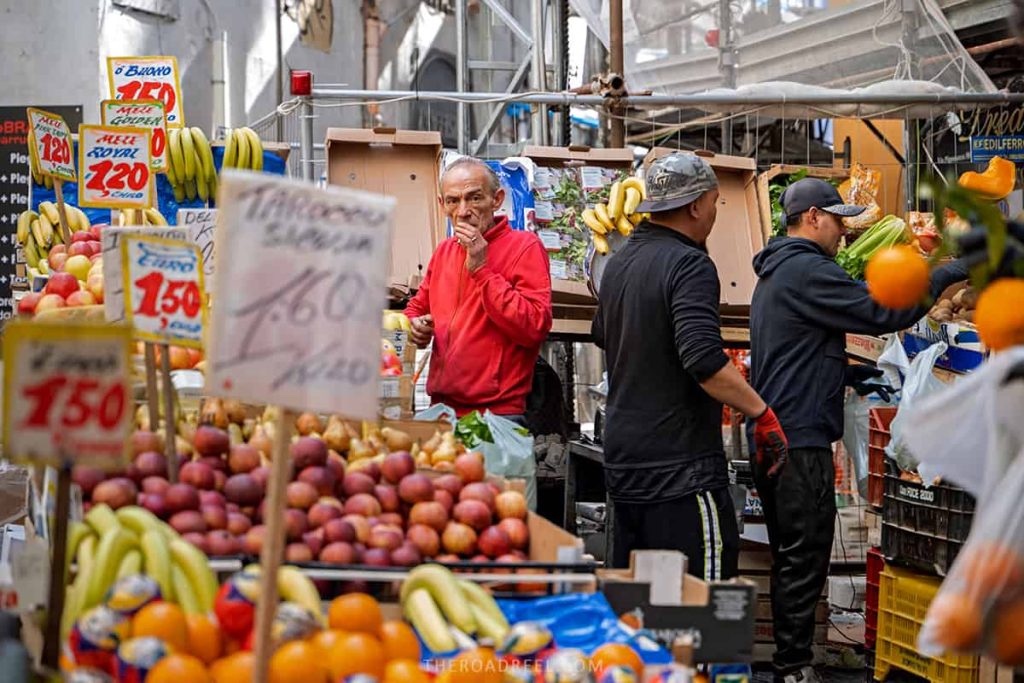 2 days in Naples, Italy: La Pignasecca Market, fruit stall and a vendor wearing red