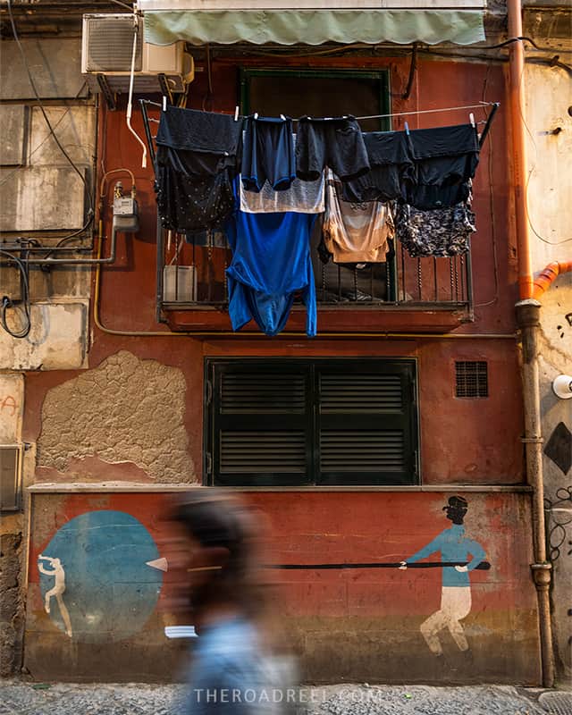 quartieri spagnoli naples laundry hanging on the balcony above colorful mural