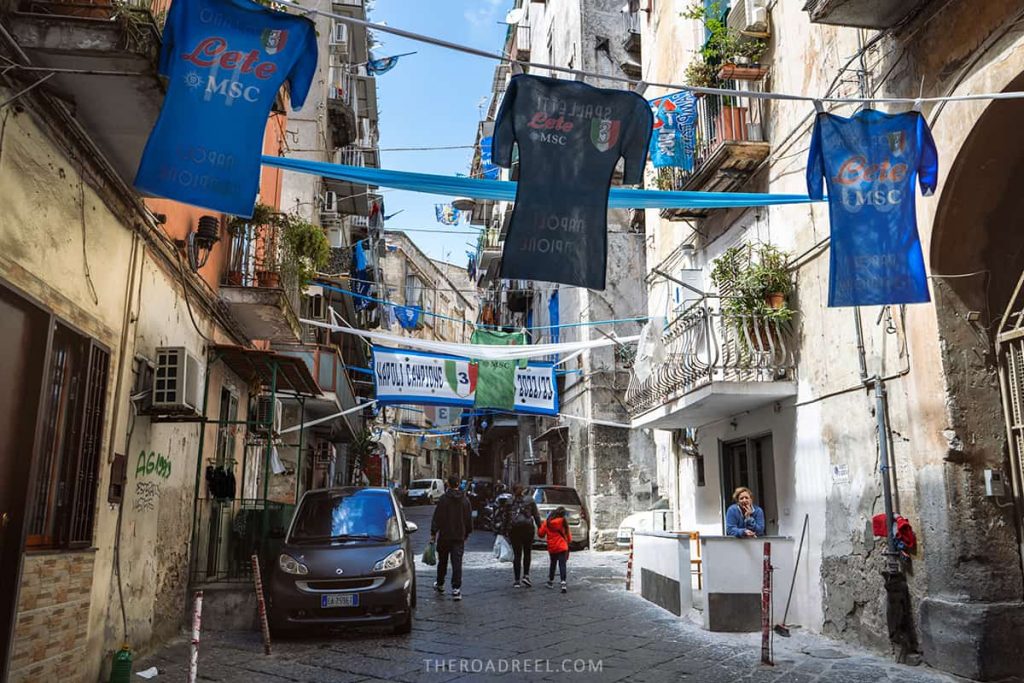 Street in Naples decorated with football team flags and t-shirts