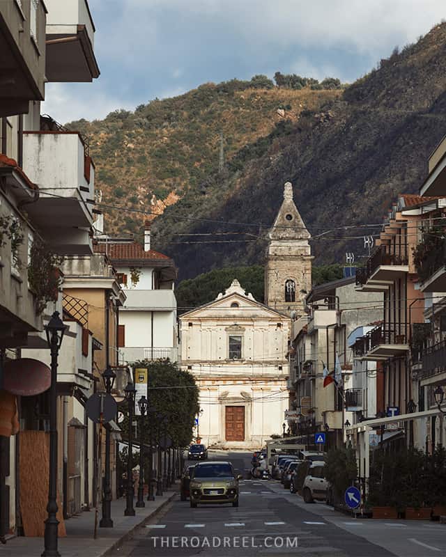 a mountain behind the church at the end of a street in Parghelia seaside town in Calabria